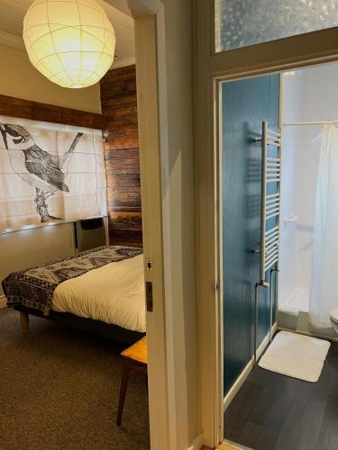 a bedroom with a bed and a sliding glass door at Treehouse Patagonia in Puerto Natales