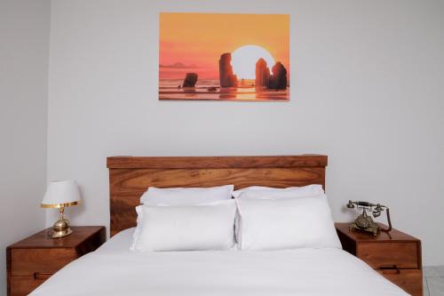 a bed with white sheets and pillows in a bedroom at Luxury & modern 1 Bedroom apartments in Munyonyo-Kampala in Kampala