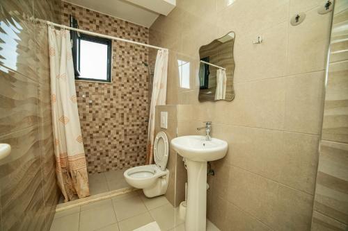 a bathroom with a toilet and a sink at Apartments IL GUSTO in Ulcinj