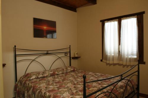 a bedroom with a bed and a window at Camping Ali Baba in Ceriale