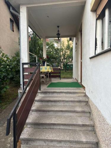 a stairway leading up to a house with a table at Vila Vuković in Leskovac