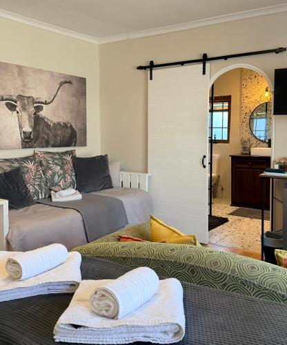 a room with two beds and a sliding glass door at Dolphin Circle Bed and Breakfast in Plettenberg Bay