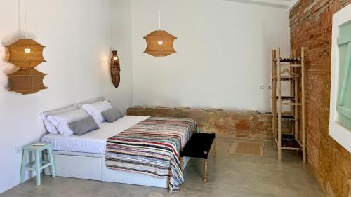 a bedroom with a bed with a blanket on it at Casa D'avó Souzinha in Ermidas