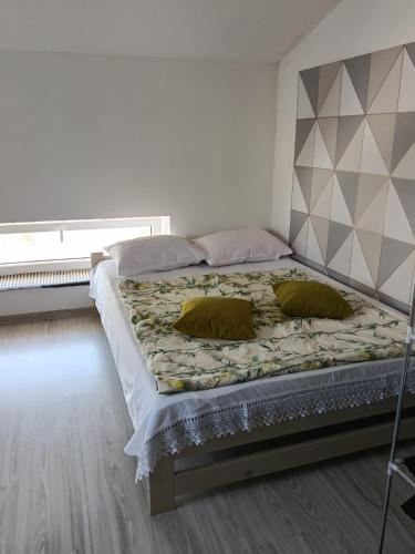 a bed with two pillows on it in a bedroom at Pokoi dwuosobowy in Włodawa