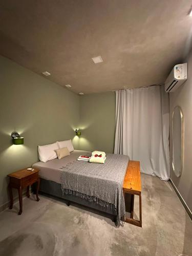 a bedroom with a bed and a table in it at Casa Super Paradise in Rio Tinto