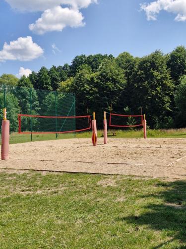 a volley ball court with a net in a field at Apartament BLASK Jeziora in Augustów