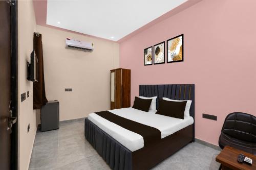 a bedroom with a bed and a chair in it at Hotel O Global Residency in Gurgaon