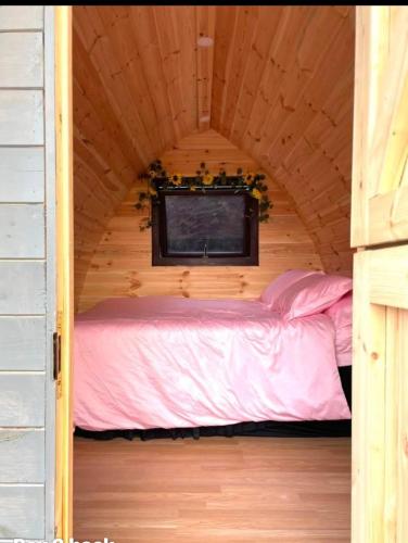a small bedroom with a bed in a cabin at Buttys place in Abergavenny