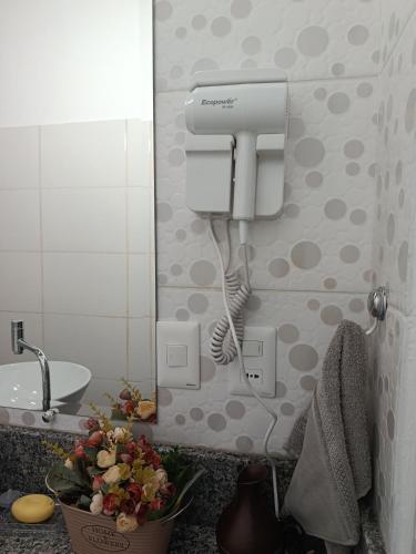 a bathroom with a hair dryer and a sink at Turquesa in Hernandarias