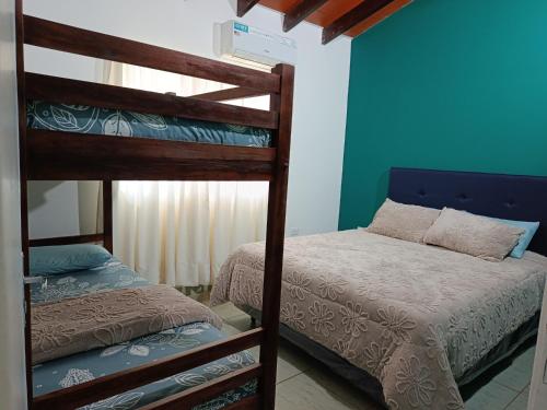 a bedroom with two bunk beds and a bed at Turquesa in Hernandarias