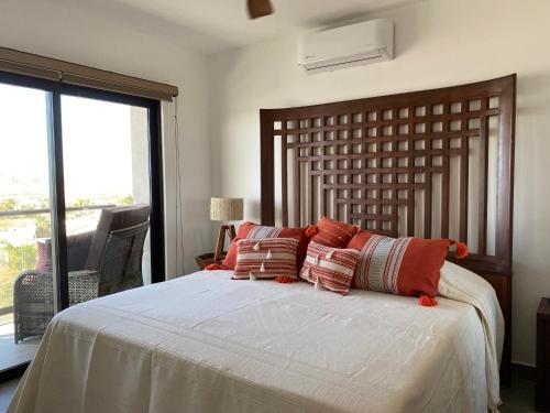 a bedroom with a large bed with pillows on it at Sunset view Penthouse 302 in Cabo San Lucas
