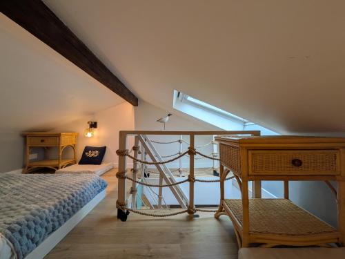 a attic bedroom with a bed and a window at Dieu Bé Nice in Nice