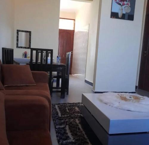 a living room with a couch and a table at Migzhome in Dodoma