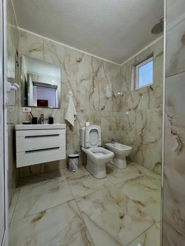 a bathroom with a toilet and a sink and a mirror at Home Lin in Lin