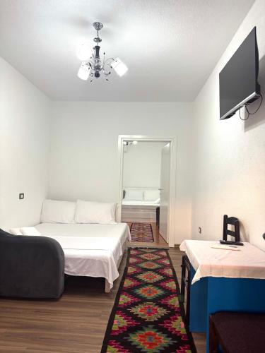 a room with two beds and a tv and a rug at Home Lin in Lin