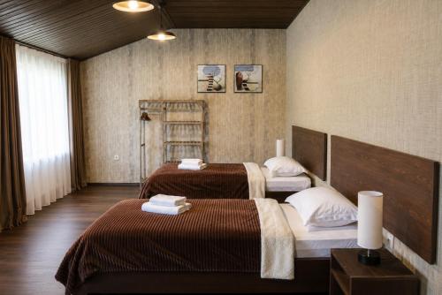 two beds in a hotel room with two beds sidx sidx sidx at Hotel Eden Mestia in Mestia