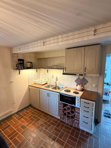 a small kitchen with a sink and a stove at Gästis in Borrby