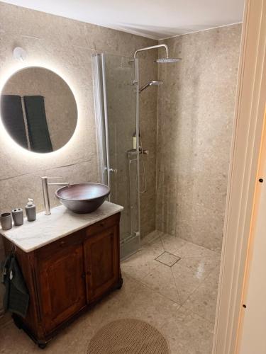 a bathroom with a sink and a shower with a mirror at Gästis in Borrby