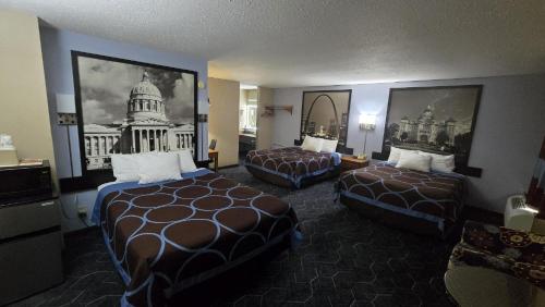 a hotel room with two beds and a picture of the us capitol at Super 8 by Wyndham O'Fallon MO/St. Louis Area in O'Fallon