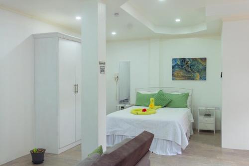 a bedroom with a bed with a tray on it at Agape Suites-Room 2-Ground Floor in Soufrière
