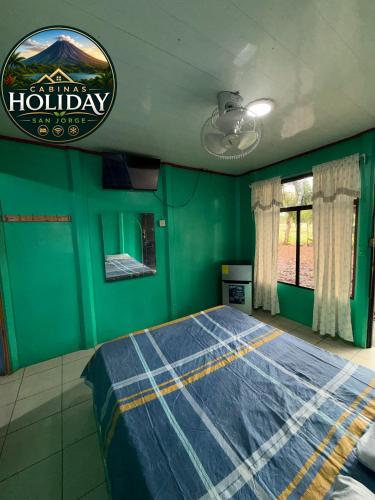 a bedroom with a bed in a green room at Holiday San Jorge in Fortuna