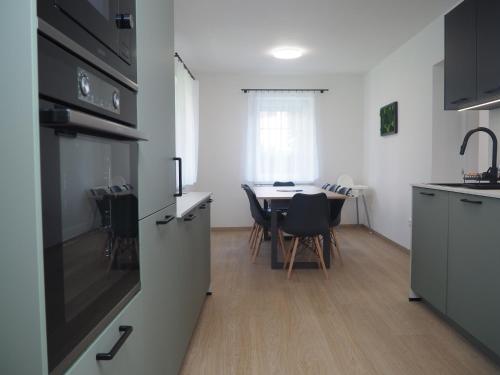 a kitchen and dining room with a table and chairs at Popelucha in Lomnice nad Popelkou