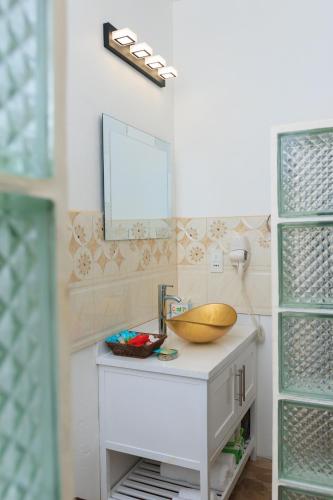 a bathroom with a sink and a mirror at Agape Suites-Room 3- 1st Floor in Soufrière
