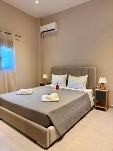 a bedroom with a large bed with two towels on it at STV Royal Apartments 3 in Areopoli