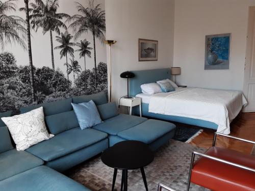 a living room with a couch and a bed at The Stage Door Apartment in Debrecen