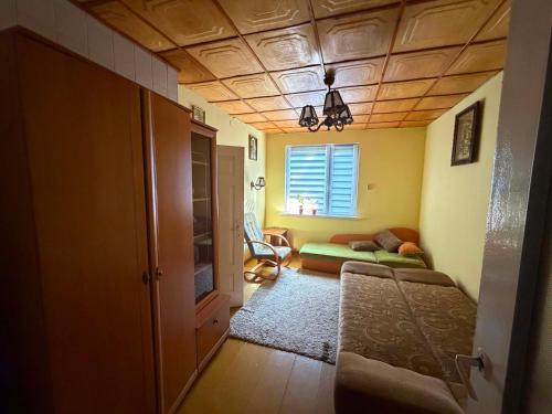 a living room with a bed and a window at Domek wakacyjny agroturystyka, Długie Grodzieckie 10 in Wszebory