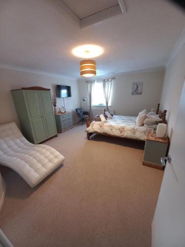 a large bedroom with two beds and a window at Foxy stays in Tanfield