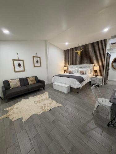 a bedroom with a large bed and a couch at Blue Cow Guest Farm in Cornville