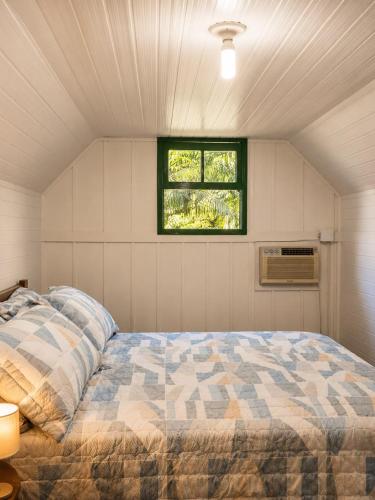 a bedroom with a bed and a window at Canto da cascata in Gramado