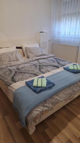 a bed with two pillows on top of it at sweet home in Nemila