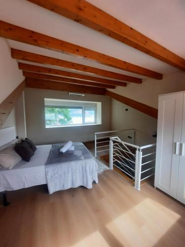 a bedroom with a large bed in a attic at Vista Real in Mugardos