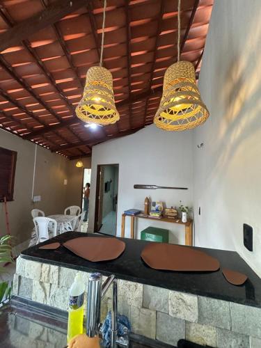 two lights hanging from the ceiling of a kitchen at Maruva Chalé in Aquiraz