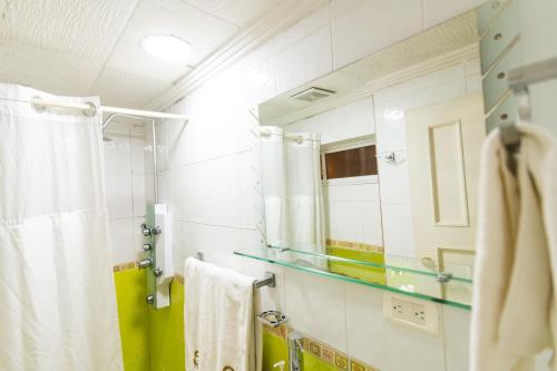 a bathroom with a shower and a mirror at Hotel Campanario in Cuenca