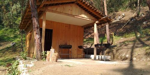 a wooden cabin with a large door in a forest at Aldea Axocobaca in Zoquitlán