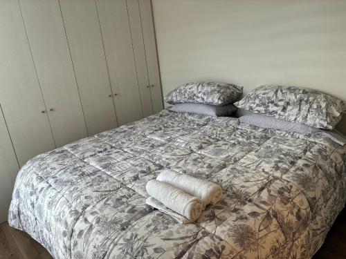a bedroom with a bed with pillows on it at Marina del Sol Executive Apartment in Talcahuano