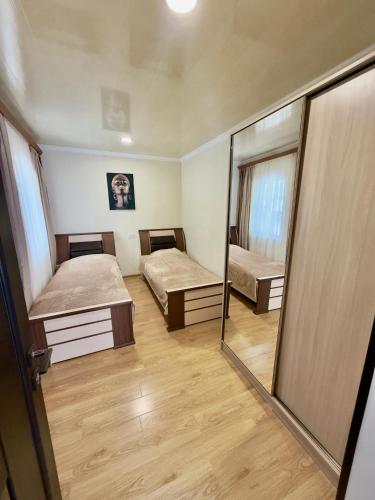 a small room with two beds and a mirror at Home Ler in Yeghipatrush