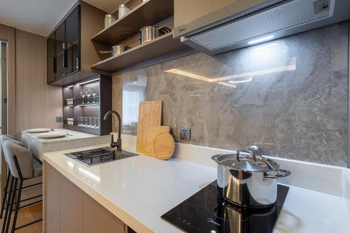 a kitchen with a counter top with a tea kettle at New Capri Condo in Bang Tao by Lofty in Ban Thalat Choeng Thale
