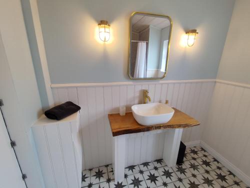 a bathroom with a sink and a mirror at Mayo Glamping in Castlebar