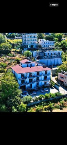 an aerial view of an apartment complex with blue buildings at Hotel Idi in Vlorë
