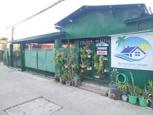 a green building with plants on the side of it at SJ Transient House in San Fernando