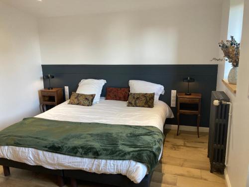a bed with two pillows on it in a room at Le Tilleul in Pluvigner