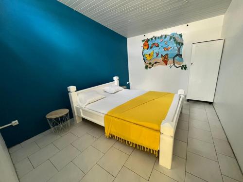 a bedroom with a bed and a painting on the wall at Villa LA SUZANNA in Pointe-Noire