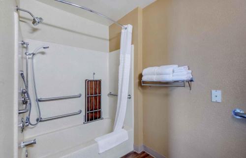 a bathroom with a shower and some towels at Extended Stay America Suites - Greensboro - Airport in Friendship