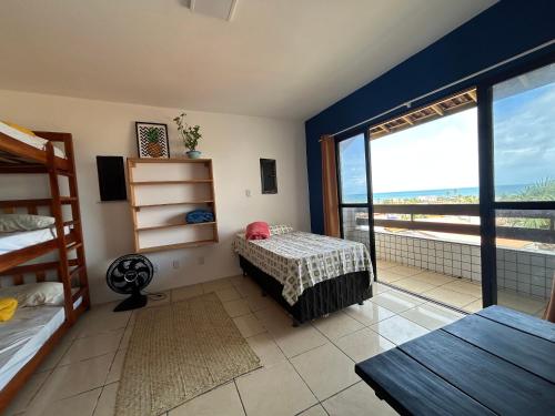a bedroom with a bed and a view of the ocean at Salvador Backpackers House in Salvador