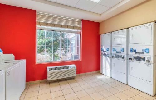 a kitchen with red walls and white appliances at Extended Stay America Suites - Chesapeake - Greenbrier Circle in Chesapeake