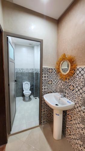 a bathroom with a sink and a toilet at VibeLine Surf Camp in Tamraght Ouzdar
